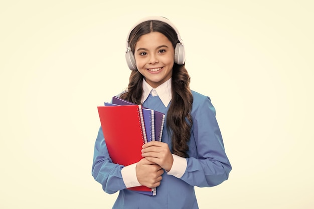 School child girl with headphones and book isoalted on white background