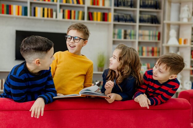 School children in the library reading books, doing homework, prepare for lessons