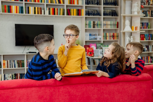 School children in the library reading books, doing homework, prepare for lessons