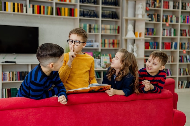 School children in the library reading books, doing homework, prepare for lessons