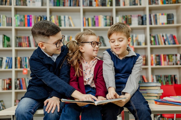 School children in the library reading books, doing homework, prepare for lessons