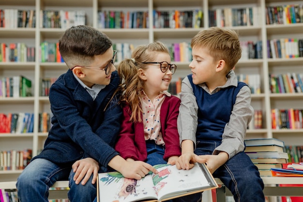 School children in the library reading books, doing homework, prepare for lessons