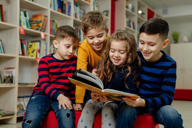 school children in the library reading books, doing homework, prepare a school project for lessons