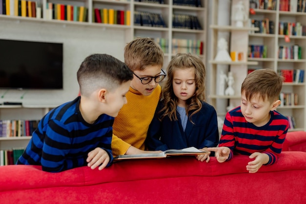 school children in the library reading books, doing homework, prepare a school project for lessons