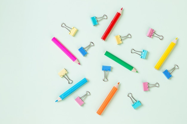 School equipment. Variety of school supplies.pastel background with colorful pencil and paper clip. concept of preparation for school. Pattern.