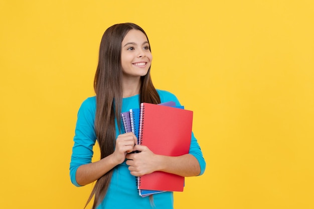 School girl with notebook back to school teen girl ready to study happy childhood cheerful kid going to do homework with books smiling teenager student Concept of education