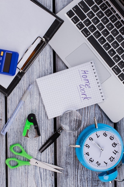 School homework concept flat lay. Accessories for learning and studying on white wooden table.