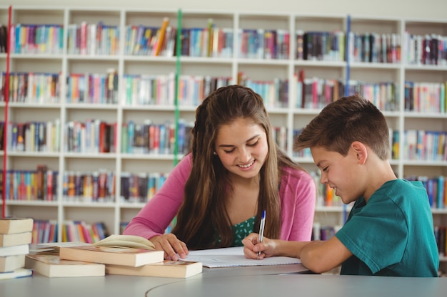 School kids doing homework in library at school