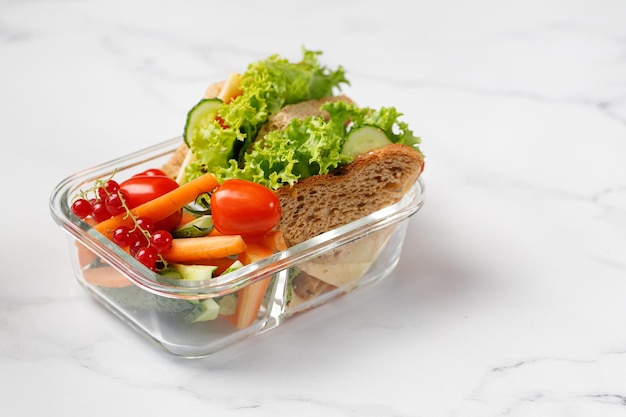 School lunchbox with a sandwich toast snack with kid's hands Container box with takeaway school food