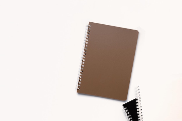 School notebook on a white background, spiral notepad on a table. flatlay