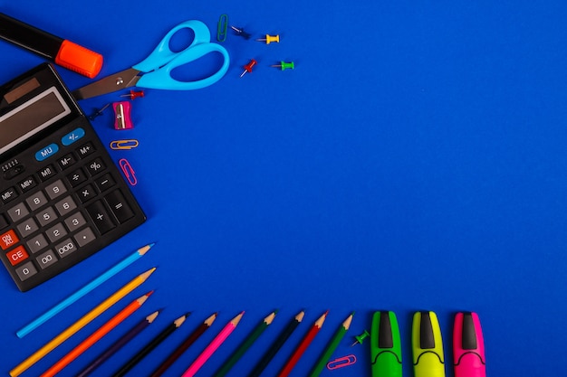 School or office supplies on blue background. Back to School. 