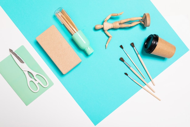 School and office supplies lie neatly on a white and blue wall