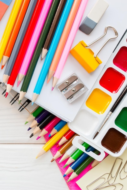 School stationery on a white wooden background and space for text