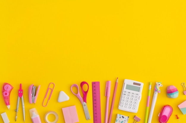 School stationery on a yellow background. Top view with copy space. Flat lay. Back to school concept.