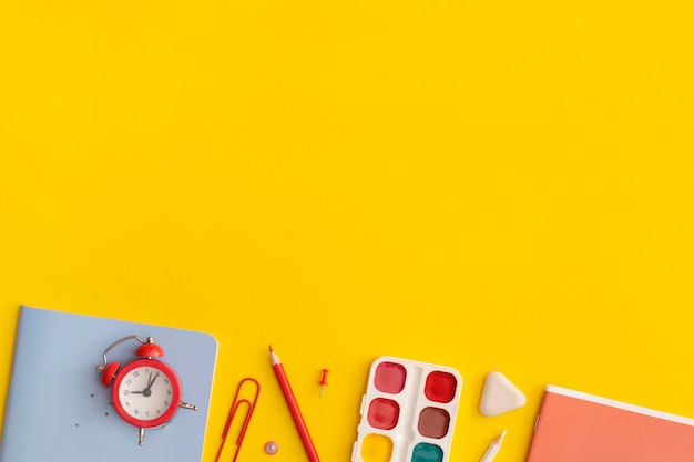 School stationery on a yellow background. Top view with copy space. Flat lay. Back to school concept.