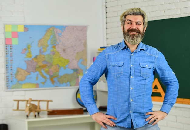 School subject History and geography Science concept Mature bearded teacher in classroom Private lesson Back to school Study with interest Man mentoring school projects Basic education