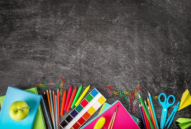 School supplies on blackboard background