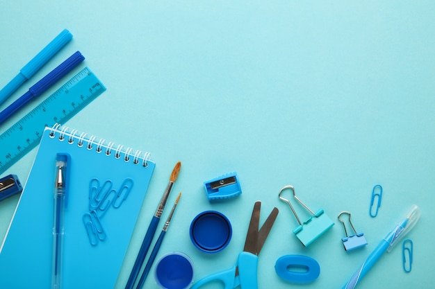 School supplies on blue background. Back to school. Flat lay. Top view