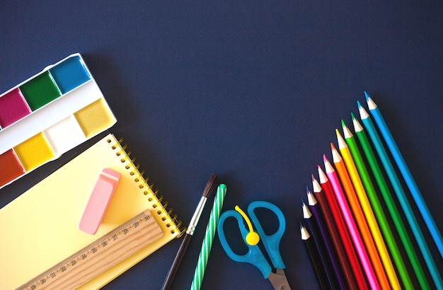 School supplies on dark blue 