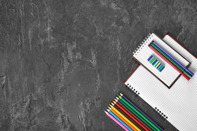 School supplies on a gray table with space for text, top view.