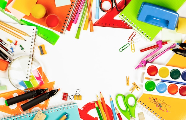 School supplies on a light background are laid out in a circle