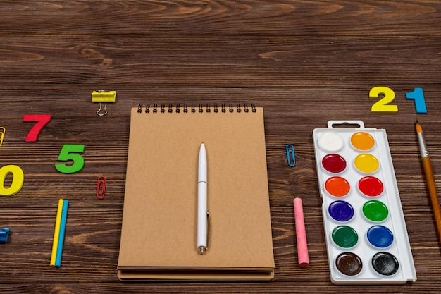 School supplies office supplies on a dark wood background