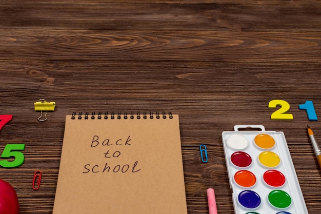 School supplies office supplies on a dark wood background