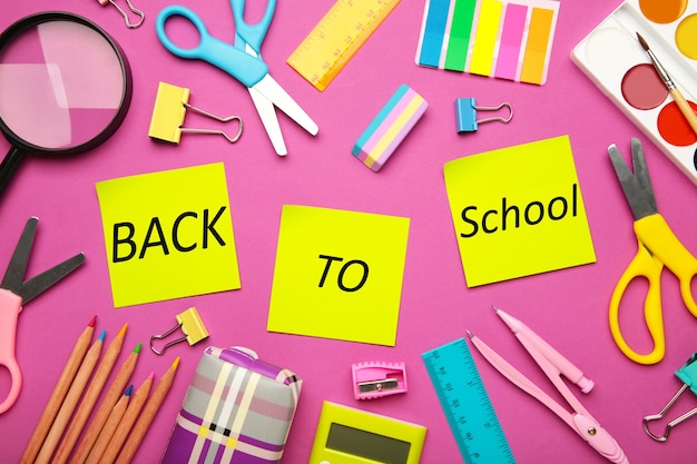 School supplies on pink background. Back to school concept.