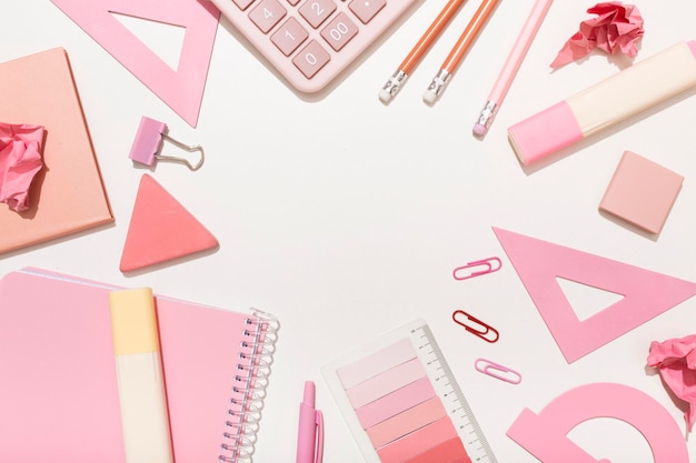 School supplies in pink colors on a white background with a place for an inscription Preparation for school