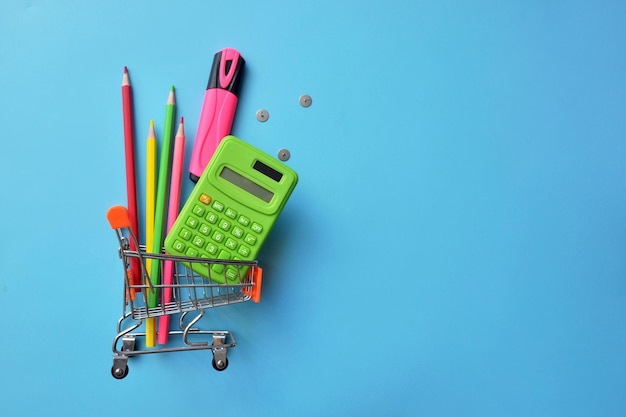 School supplies in the shopping cart, buying school supplies