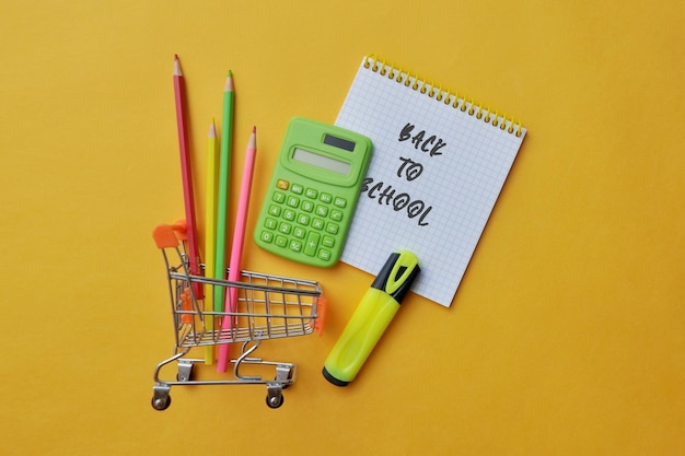 School supplies in the shopping cart, buying school supplies