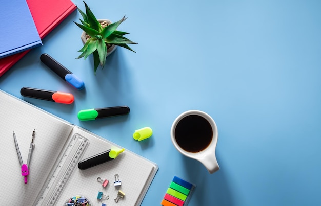 School supplies stationery on a blue background copy space