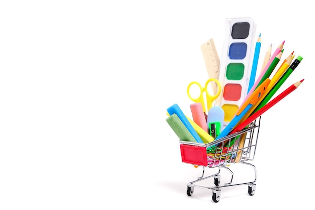 School supplies and stationery in a shopping basket white backgroundPreparing child for school year