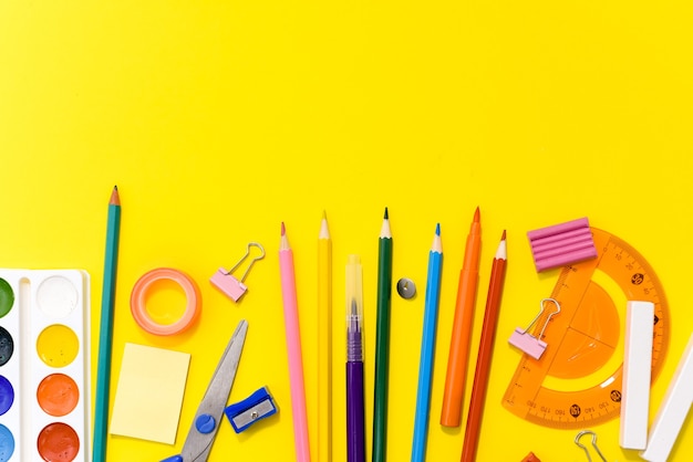 School supplies stationery on yellow.