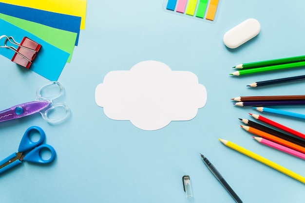 School supplies with blank white note or card, top view