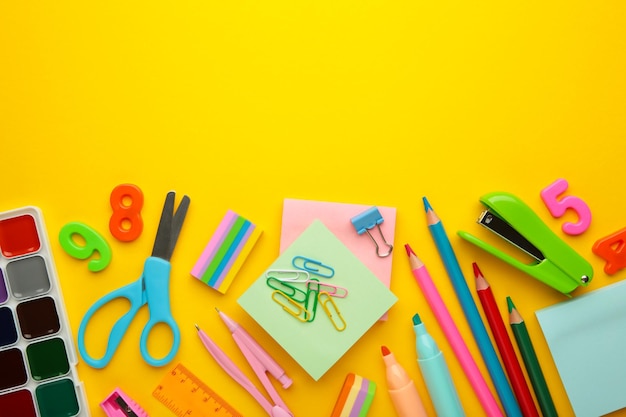 School supplies on yellow background Top view