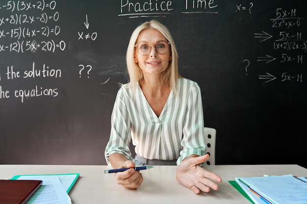 School teacher having online virtual class in classroom webcam view