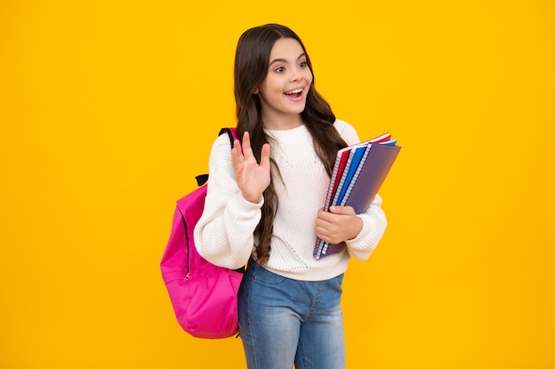 School teenager child girl with book and copybook Teenager student isolated background Learning and knowledge Go study Education concept Happy face positive and smiling emotions