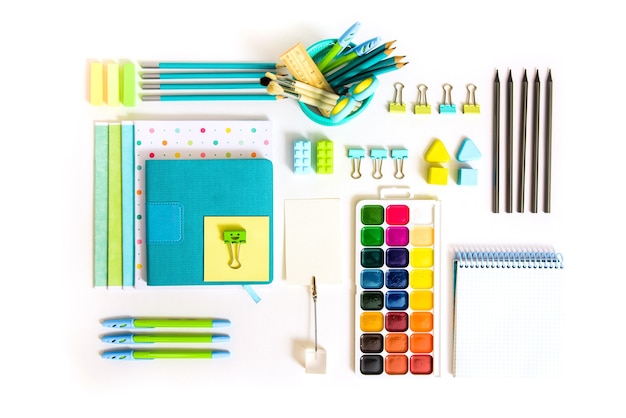 School tools on white background. top view.back to school, school supplies - pencils and paints, ruler and eraser, paper clips and scissors, notepads and notebooks.