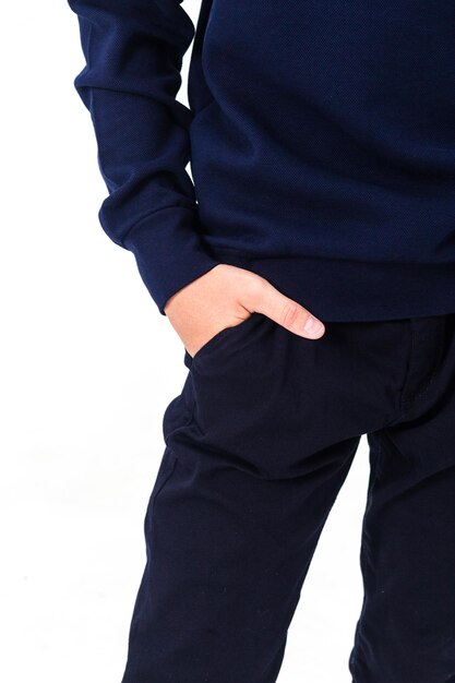 Photo school uniform black trousers with pockets the boy keeps his hands in his pockets vertical photo