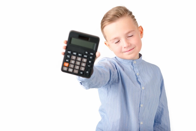 Schoolboy holding calculator Portrait of funny cute 10s boy close eyes White background