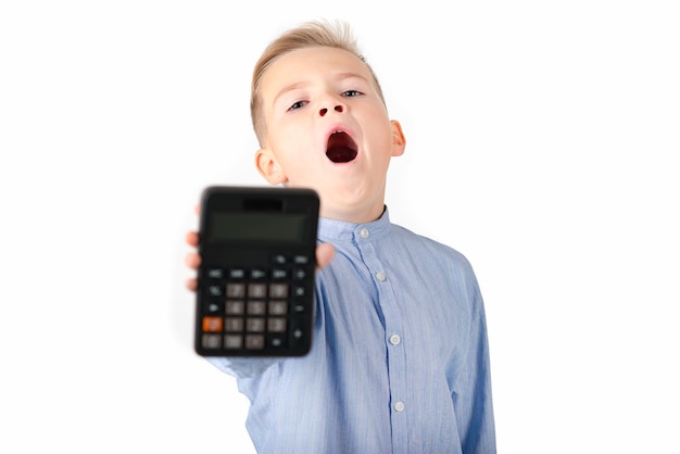 Schoolboy holding calculator Portrait of funny cute 10s boy tired child with calculator looking at camera White background