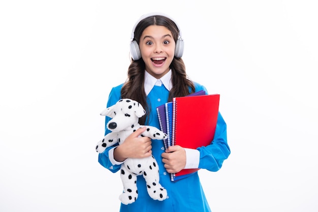 Schoolchild teenage student girl with toy on isolated studio background School and education concept