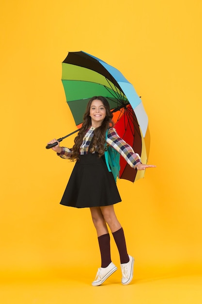 Schoolgirl daily life Girl with umbrella Rainy day Happy childhood Kid happy schoolgirl with umbrella Fall weather forecast Rainy september Towards knowledge Schoolgirl with backpack