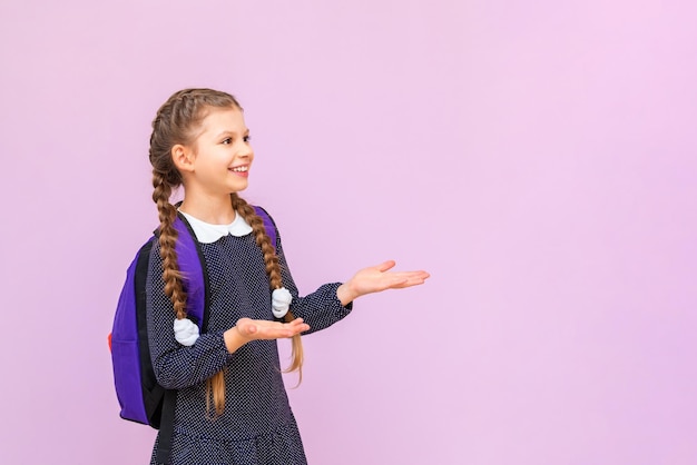 The schoolgirl is very surprised and confused the girl in a polka dot dress on an isolated background