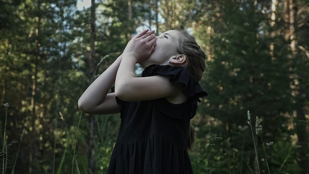 Schoolgirl lost in dark forest and screams crying closeup