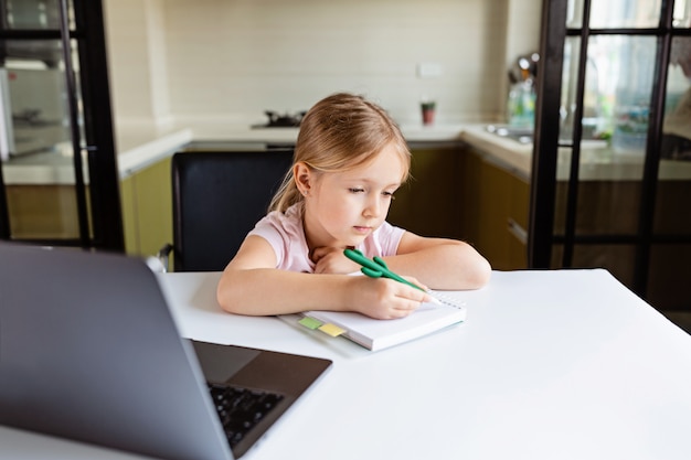 schoolgirl making homework at home