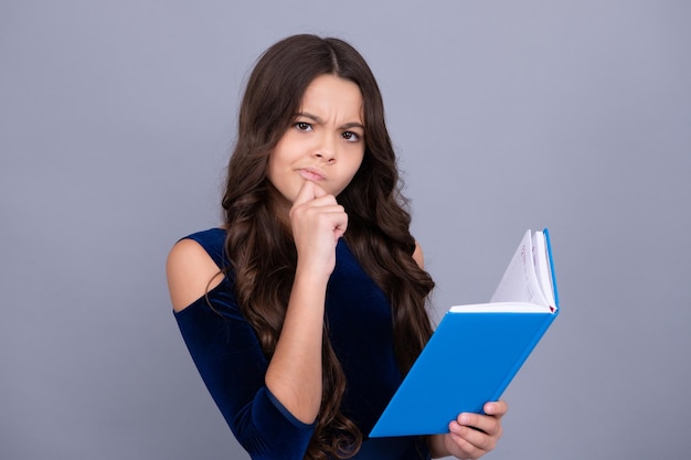 Schoolgirl student on gray isolated background Serious teenager school girl