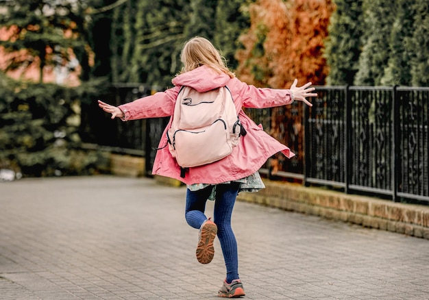 Schoolgirl walking at street