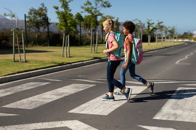 Schoolgirls crossing the road on a pedestrian crossing